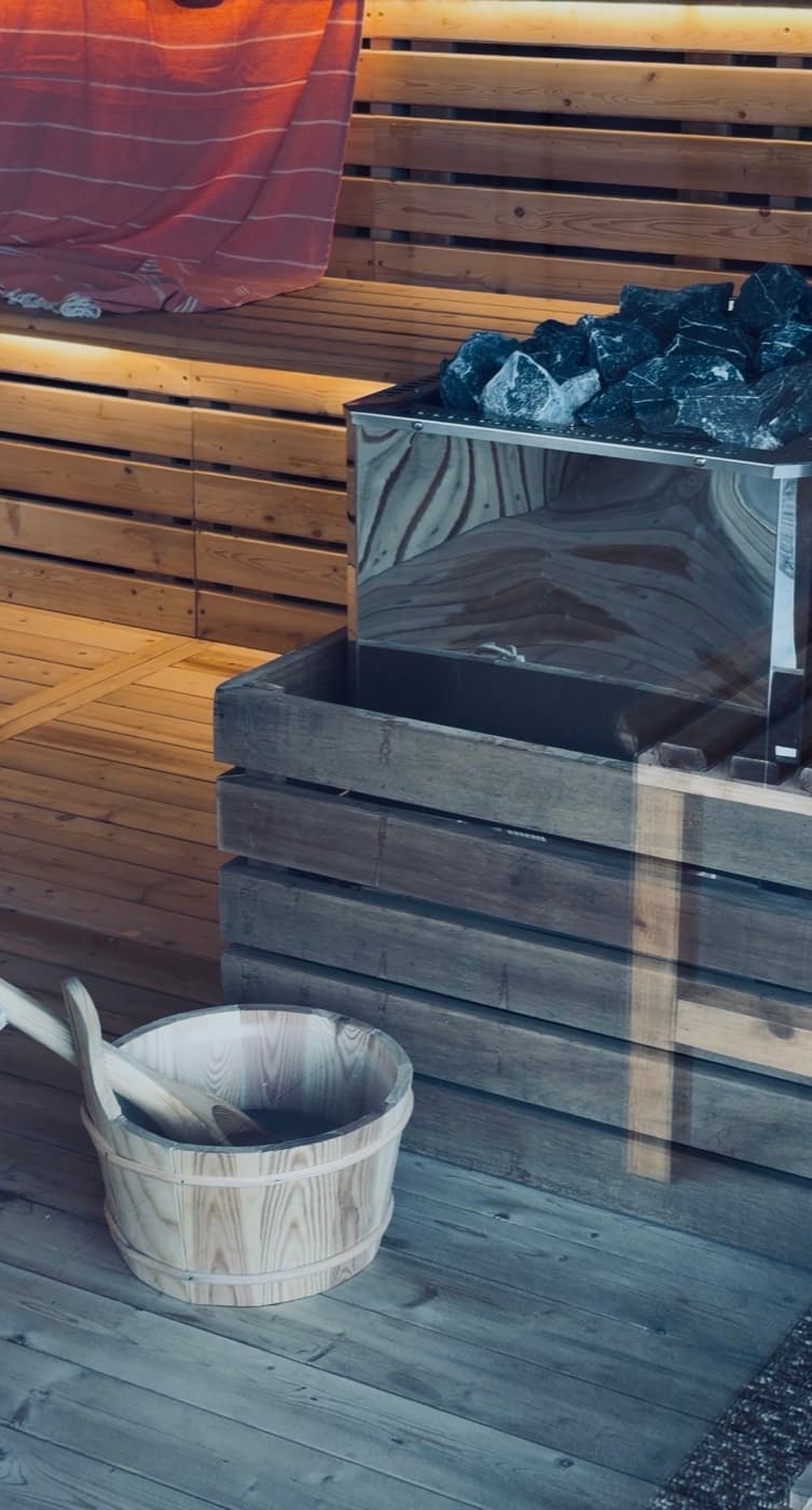 The sauna heater, stones and a cedar bucket